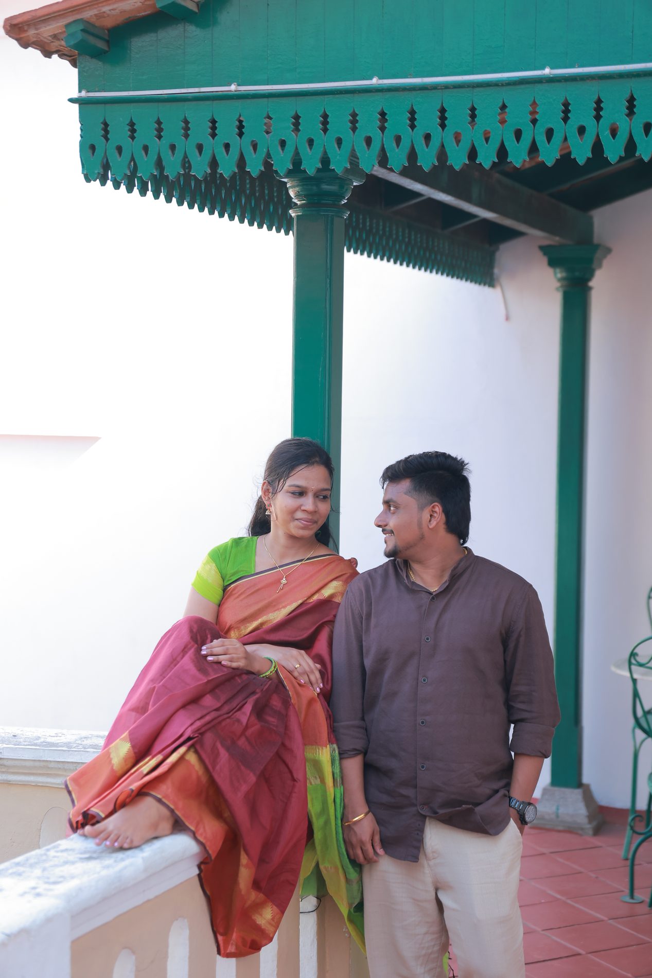 Brindha mid-twirl, saree flowing, playing hopscotch on the courtyard floor