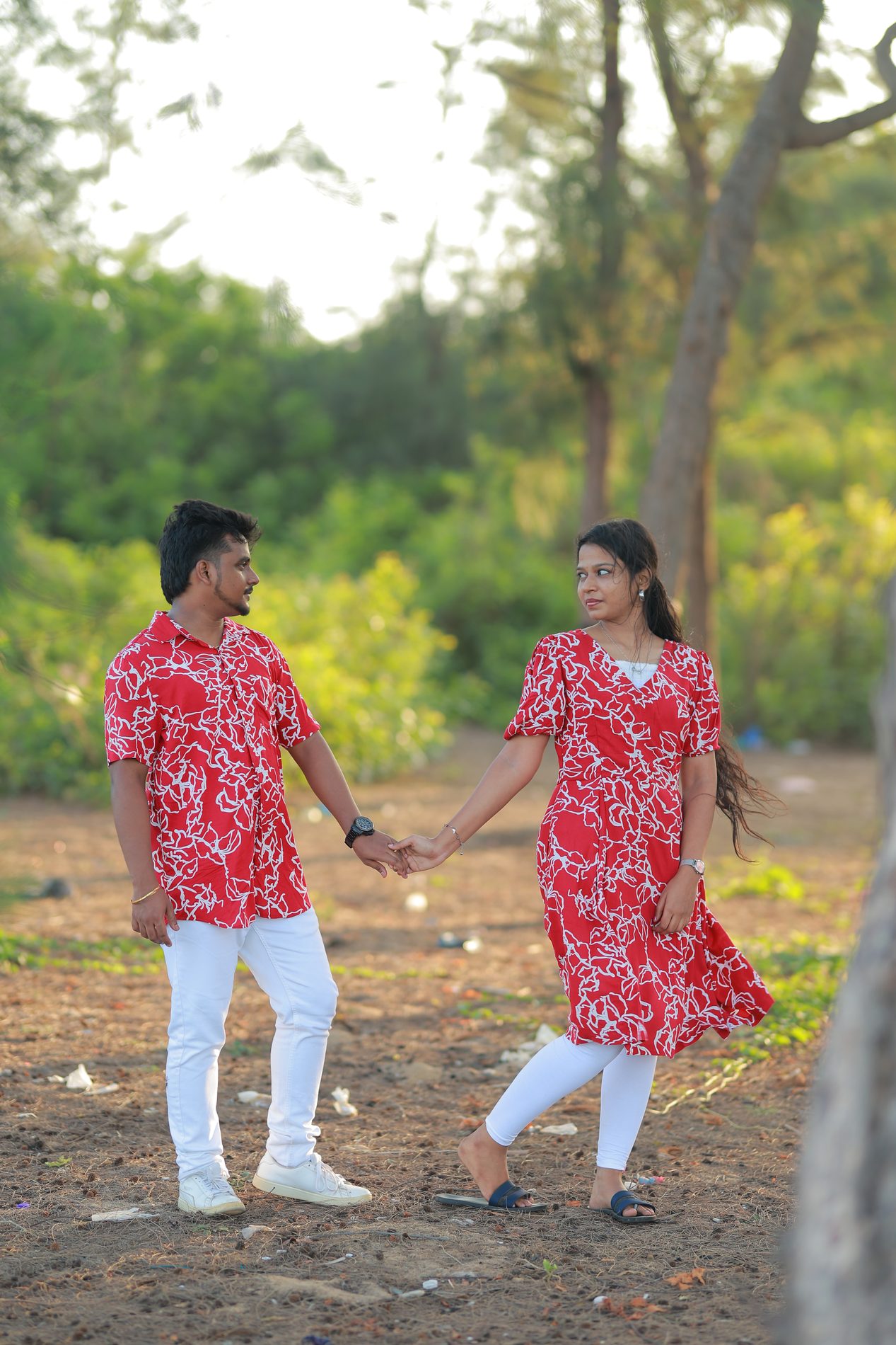 Brindha and Venkatesh on the beach at golden hour, wind in her hair