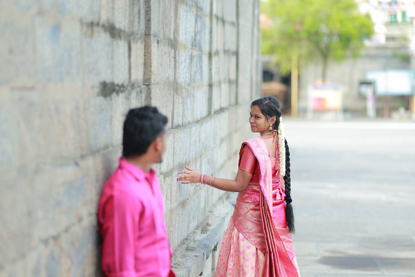 A candid moment walking along the temple's old stone wall